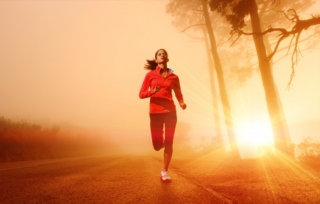 Athlete running on the road in morning sunrise training for marathon and fitness Healthy active lifestyle latino woman exercising outdoors