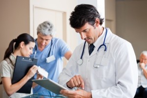 18291728 - male doctor using digital tablet